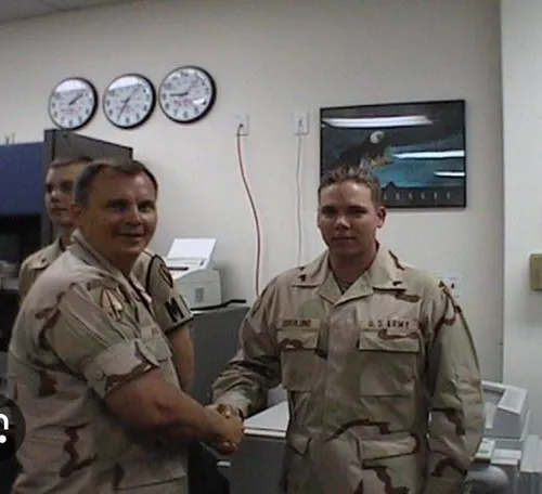 Gary congratulating a Junior NCO