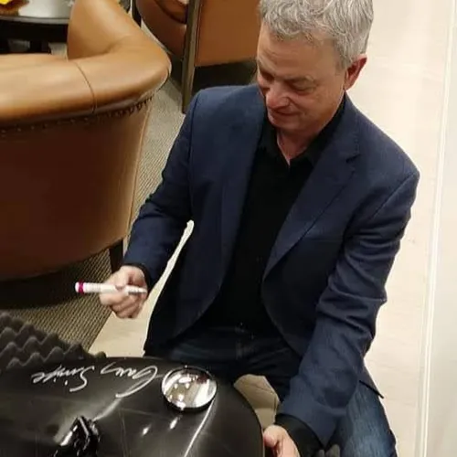 Gary Sinise signing the Custom Harley Tank