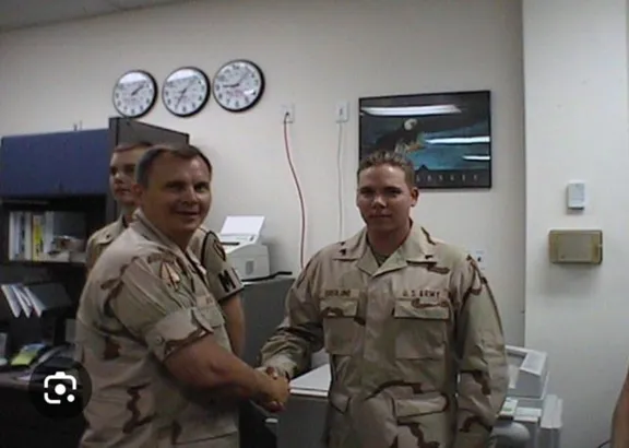 Gary congratulating a Junior NCO