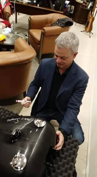 Gary Sinise signing the Custom Harley Tank